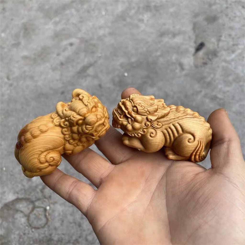 A pair of Pixiu hand-held ornaments carved from thuja boxwood for men to play with and to attract wealth.